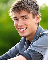 photo of a young man with a great smile after having undergone orthodontic treatment
